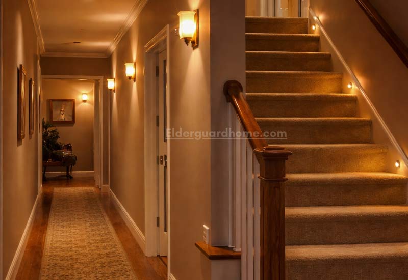 Hallway and stair lighting with wall lights and step lights improving visibility for seniors
