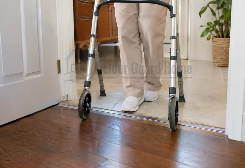 How to Tell If a Floor Transition Is Too High for a Walker - Older adult using a walker across a floor transition between two rooms